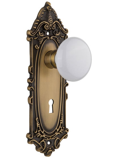 Largo Design Mortise Lock Set With White Porcelain Door Knobs in Antique Brass.